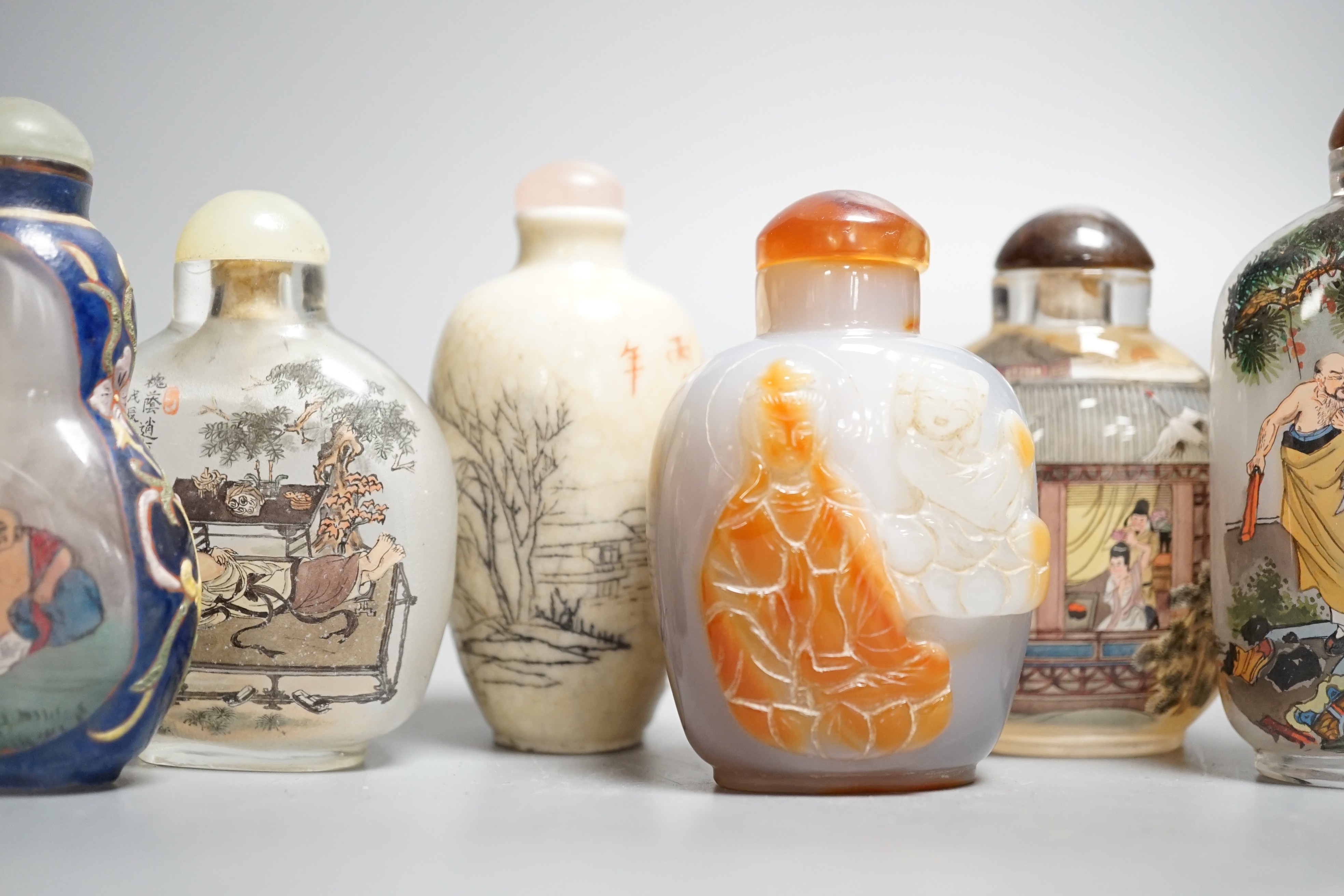 Six Chinese inside painted glass snuff bottles, an agate cameo snuff bottle and an incised crackle glaze snuff bottle, tallest 9cm